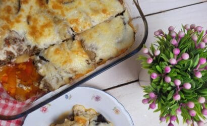 Top view of a cheesy baked moussaka served on a plate, perfect for food photography.