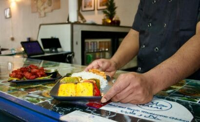 Close-up of freshly prepared Indian cuisine with colorful vegetables and cooked rice.