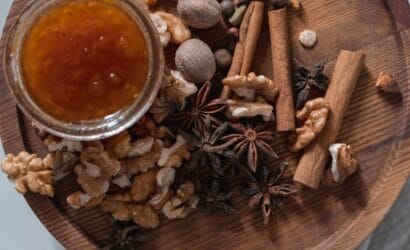 A jar of Kangaroo Island Ligurian honey with a golden, smooth texture, surrounded by fresh honeycomb and local produce, from Europa Travel Hub.