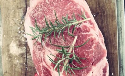 A beautifully seared kangaroo steak, served with native Australian herbs and vegetables, representing the flavors of Northern Australia.